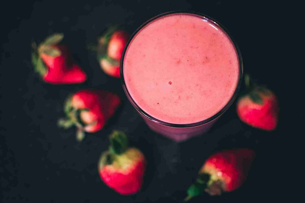 clear drinking glass with strawberry smoothie