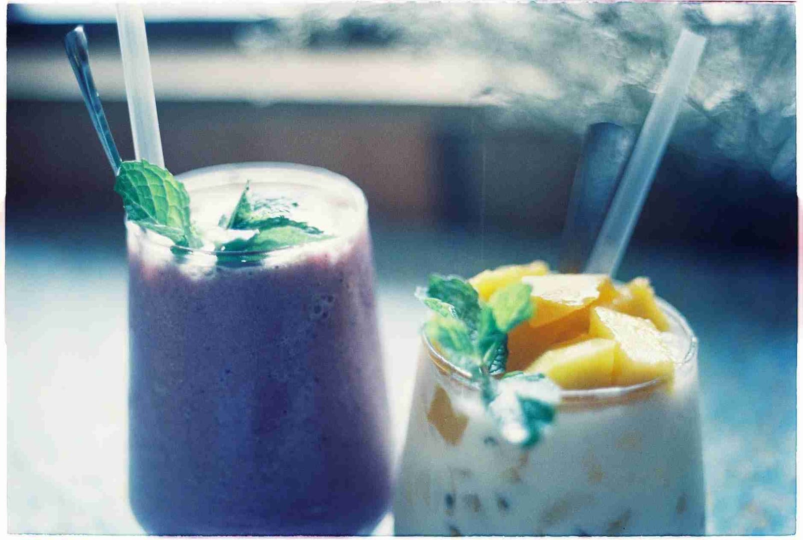 fruity smoothies in clear glasses