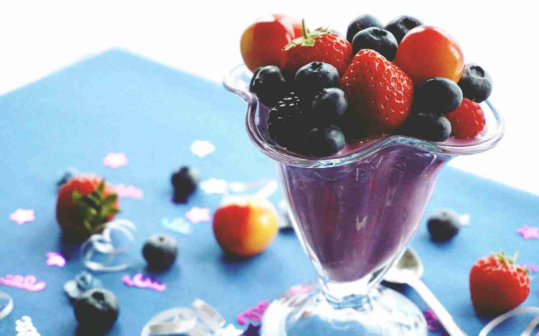 strawberries and blueberries on footed cup smoothie diet