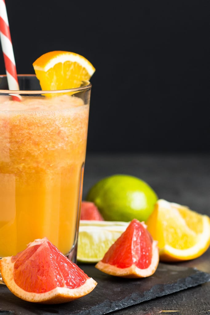 citrus smoothie and fresh sliced fruit